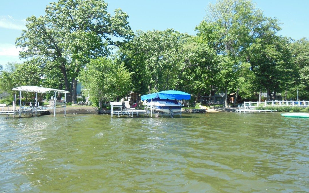 Lakeshore docks with blue canopy boat